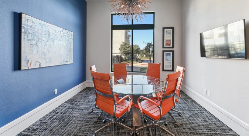 an office room with a table and chairs